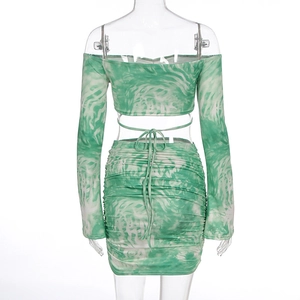Detail view of lace-up back design and ruched skirt on green tie-dye two-piece set