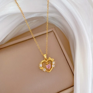 Luxury heart bow necklace with pink gemstone and small diamonds on gold titanium chain