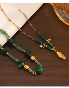 Vue macro du bracelet bohème en malachite avec breloque main dorée et chaîne acier inoxydable