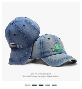 Close-up of distressed denim baseball caps with vintage embroidery and worn texture