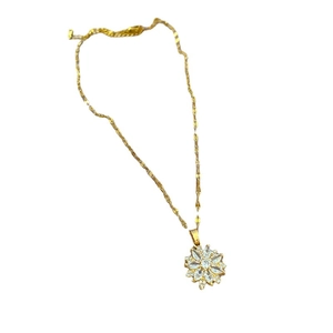 Titanium steel gold necklace with sparkling crystal flower pendant on white background