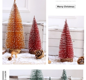 Mini Christmas trees with snow spray and wooden bases for festive desktop decoration