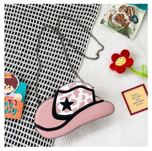 Pink cowboy hat chain bag with star pattern and cow print details in a creative layout