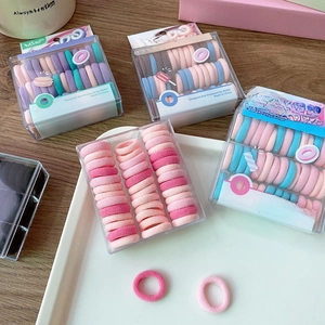 Macaron colored children's elastic hair bands in a clear box with diverse pastel tones
