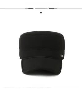 Close-up of black cadet cap featuring knitted texture and small square metal logo detail
