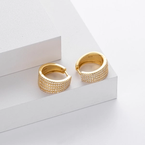 Detailed close-up of 925 sterling silver stamp on gold-plated zircon hoop earrings