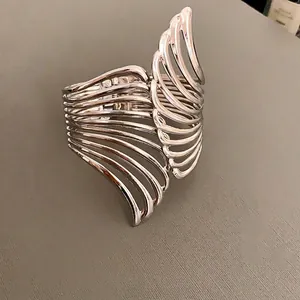 Silver hollow leaf open cuff bracelet with vintage textured wing design for women