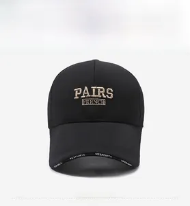 Detailed embroidery of PAIRS FRENCH text on a black cotton baseball cap with ventilation holes