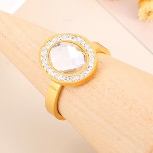 Macro shot of a 18K gold-plated ring with an oval main stone and a classic halo of diamonds