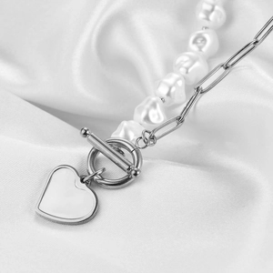 Detail of silver heart pendant with paperclip chain, baroque pearls, and OT toggle clasp