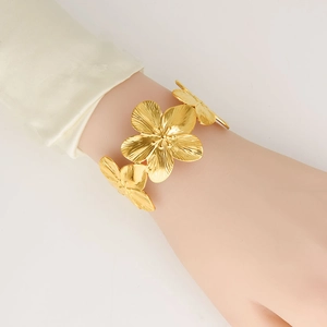 Adjustable 18K gold plated stainless steel open cuff bracelet with three textured flowers