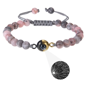 Macro detail of amazonite bead bracelet with 100 languages I Love You projection stone