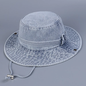 Close-up of light blue washed denim sun hat with adjustable strap and silver metal buckle