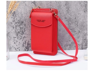Detail of red faux leather phone crossbody bag with adjustable strap and textured finish