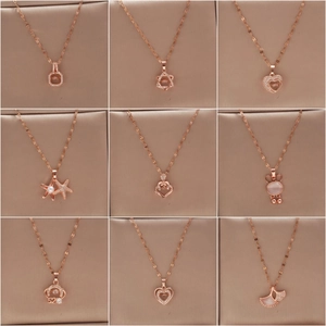 Detailed grid view of nine distinct rose gold titanium steel necklaces with diverse pendants