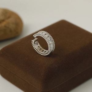Detail of silver C-shaped open ring with micro-pave rectangular zircons on jewelry box