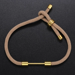 Detailed close-up of adjustable light brown braided cord bracelet with gold metal bar and clasp