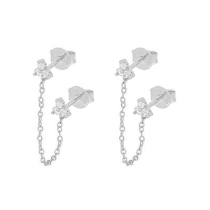 Detail of silver floral earrings with cubic zirconia stones and delicate connecting chains