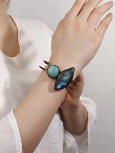 Close-up of vintage bronze cuff featuring blue labradorite and green amazonite stones
