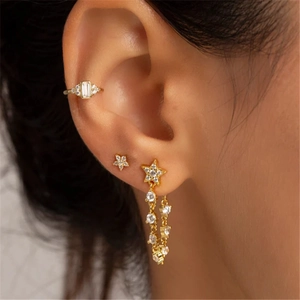 Elegant gold S925 silver star earrings with chain tassels and crystal ear cuffs on model
