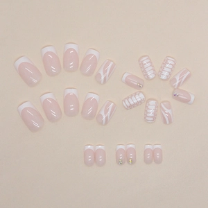 Minimalist white patterned press-on nails with small rhinestones in varied elegant designs