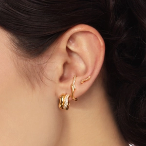 Close-up of golden S925 silver half moon earrings with pearls and zirconia studs