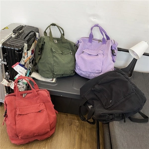 Washed canvas multi-pocket backpacks in four vintage colors on a storage box
