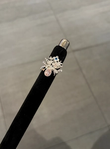 Détail d'une bague bouquet de fleurs vintage avec des zircons roses et bleus étincelants.