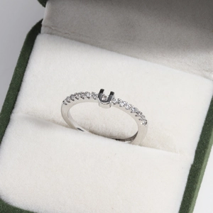 Macro shot of 18k gold plated adjustable U-shaped diamond ring in a luxury gift box