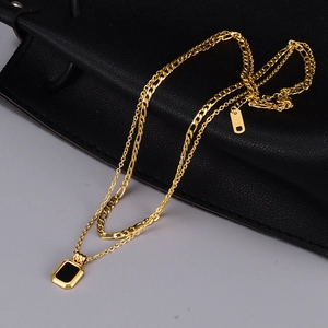 Double-layered gold necklace with black rectangular pendant and K18 hallmark detail
