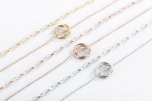 Three-layer interlocking ring necklaces in gold, rose gold, and silver finishes