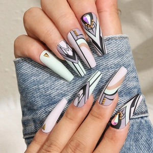 Detailed view of long trapezoid press-on nails with geometric patterns and rhinestones