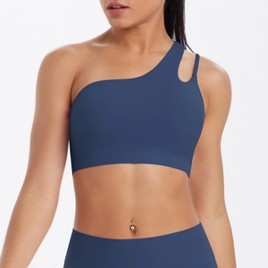 Detail view of the asymmetric strap and back hollow design on a blue sports bra