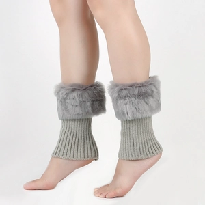 Detailed view of grey knitted leg warmers with fluffy faux fur trim and ribbed texture