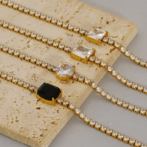 Detail of four gold-plated stainless steel tennis bracelets with zircon gemstones
