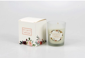 Detail of frosted glass scented candle with decorative floral gift packaging box