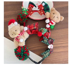 Detail of plush Christmas bear headbands on wood background for festive styling