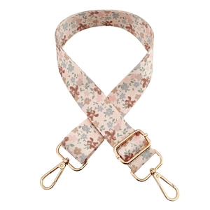Floral print wide replacement shoulder strap with gold metal swivel clasps on white background