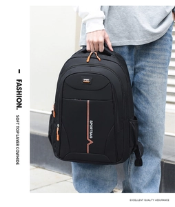 Detail of water-resistant black backpack with orange zipper accents and side mesh pocket