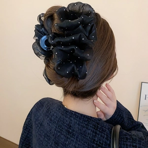 Detailed back view of a black mesh bow hair claw clip with pearls on a model