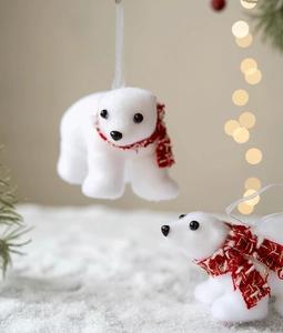 Close-up of white flocked polar bear ornament with red checkered scarf for Christmas tree