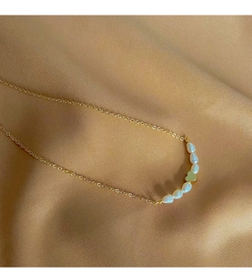 Detailed view of freshwater pearl heart necklace on elegant silk background fabric