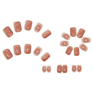 Red-brown press-on nails set with gradient white hearts and gold foil accents