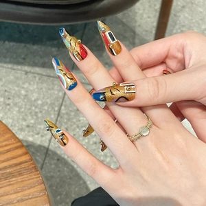 Luxury Egyptian style press-on nails with gold glitter and abstract geometric patterns