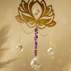 Close-up of golden lotus suncatcher with natural amethyst stones and crystal ball
