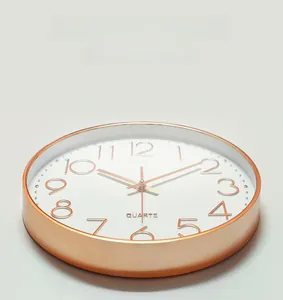 Detail view of the rose gold metal frame and high-transparency glass on the silent wall clock