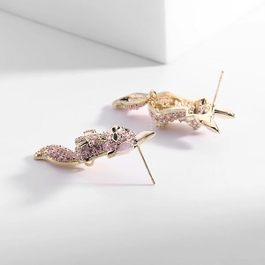 Detailed close-up of a pink fox stud earring with inlaid sparkling pink zircons