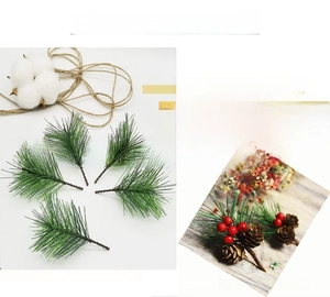 Detailed view of artificial pine needles with brown wire for DIY Christmas wreath crafts