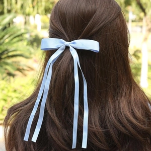 Elegant light blue polyester ribbon bow hair clip with long flowing streamers for women