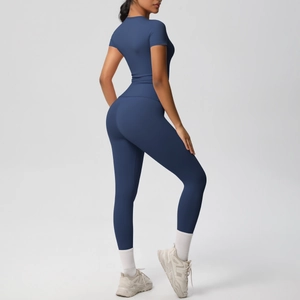 Detail of navy blue high-waist yoga leggings and slim fit tee shown from back view
